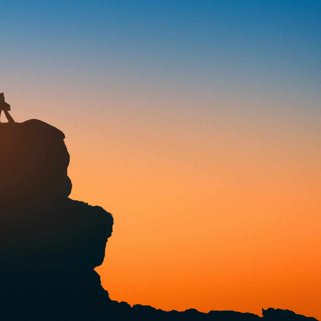 Hero: sunrise over mountains and sea with a traveler silhouette